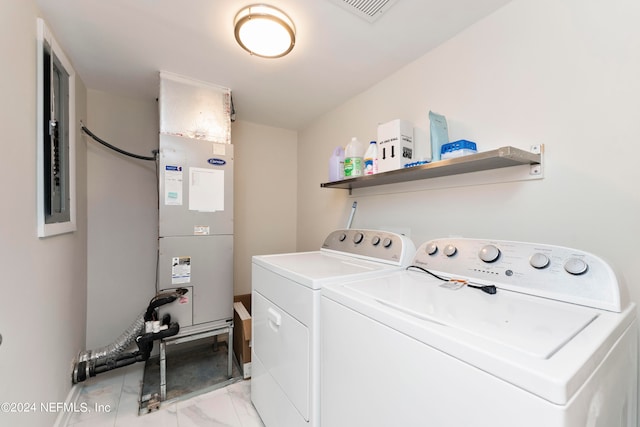 laundry area featuring heating unit and separate washer and dryer