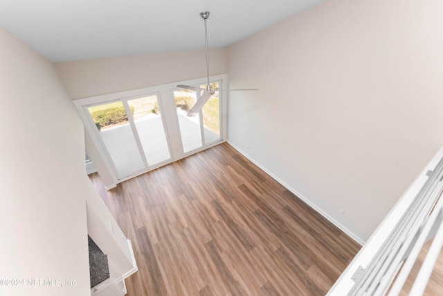 unfurnished dining area with lofted ceiling and wood-type flooring