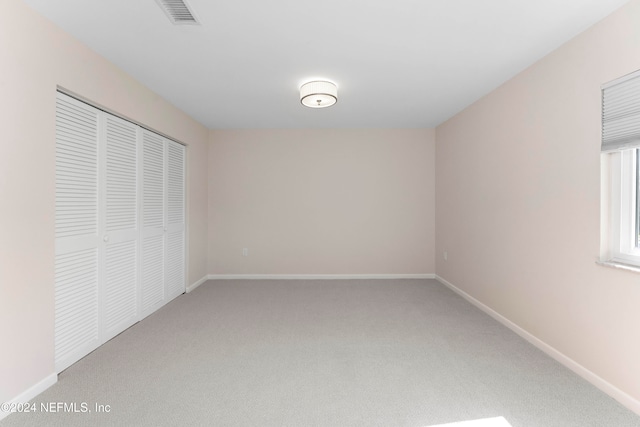 unfurnished bedroom with a closet and carpet