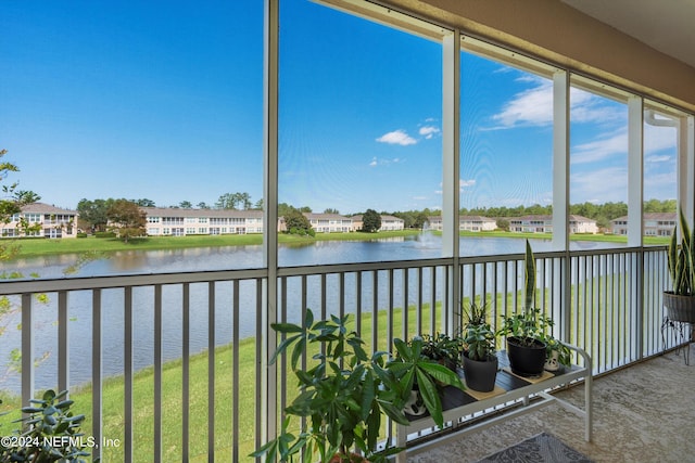 unfurnished sunroom featuring a water view