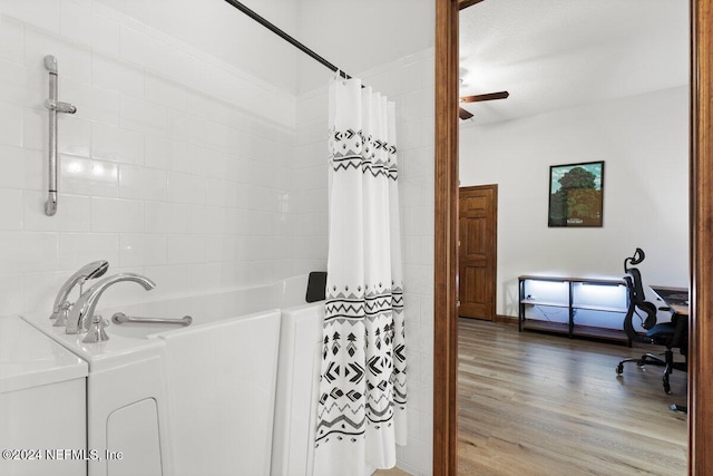 bathroom with washer / dryer and hardwood / wood-style flooring