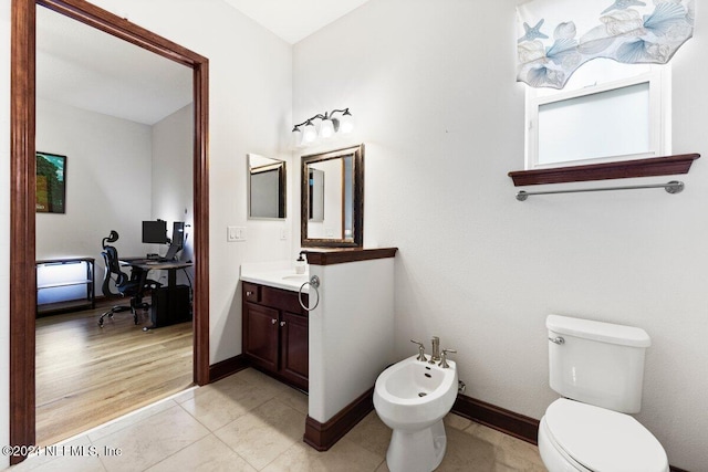 bathroom with vanity, hardwood / wood-style floors, a bidet, and toilet