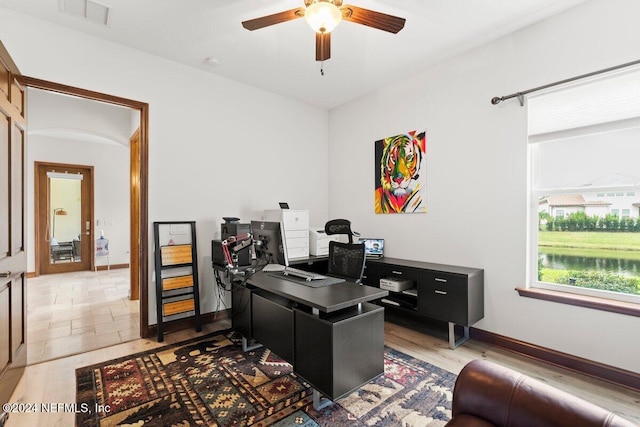 office with wood-type flooring and ceiling fan