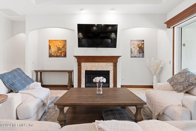 living room with a stone fireplace