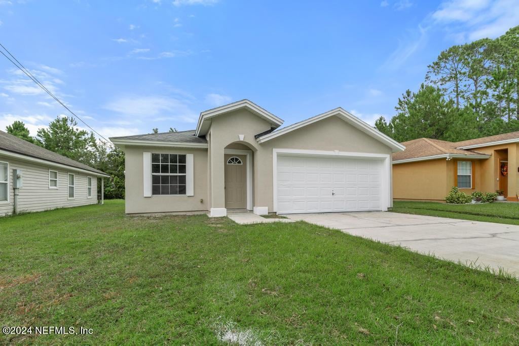 ranch-style house with a front yard and a garage