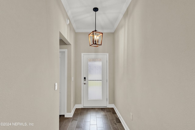 doorway to outside with crown molding, a chandelier, and dark hardwood / wood-style flooring