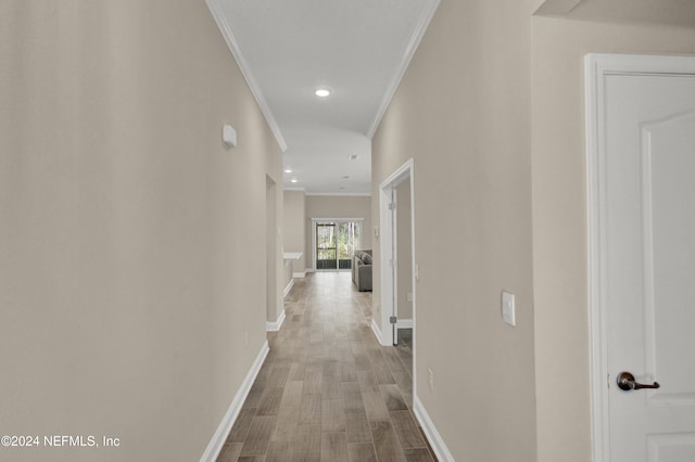 hallway featuring crown molding and hardwood / wood-style flooring