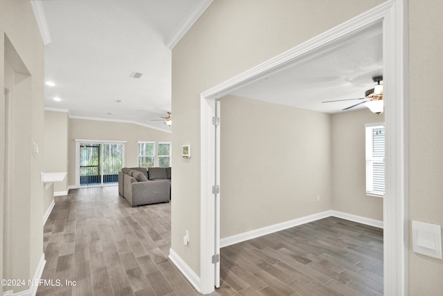 hall with light hardwood / wood-style floors and ornamental molding