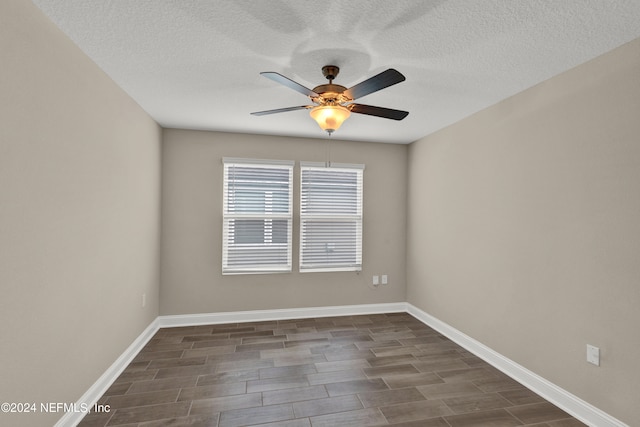 unfurnished room featuring a textured ceiling, dark wood-type flooring, and ceiling fan