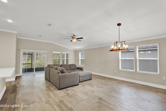 living room with lofted ceiling, crown molding, light hardwood / wood-style flooring, and ceiling fan with notable chandelier