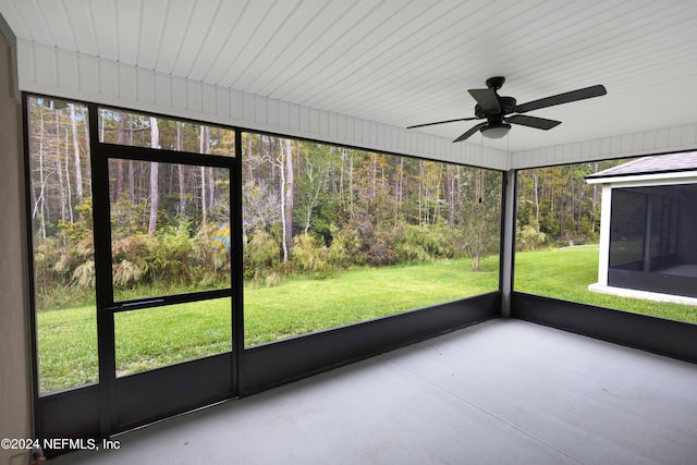 unfurnished sunroom featuring ceiling fan