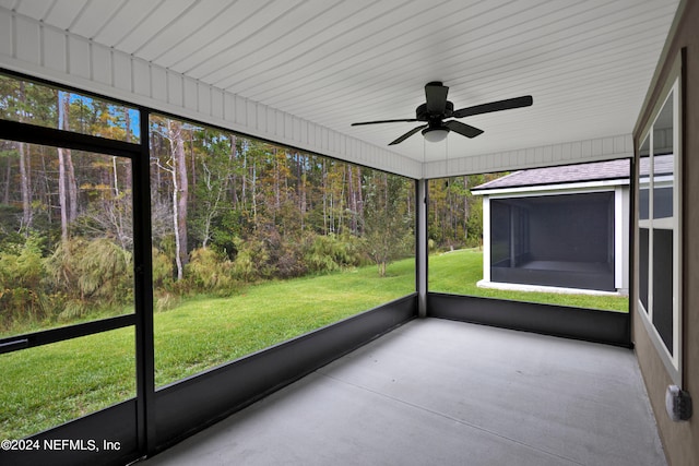 unfurnished sunroom with ceiling fan