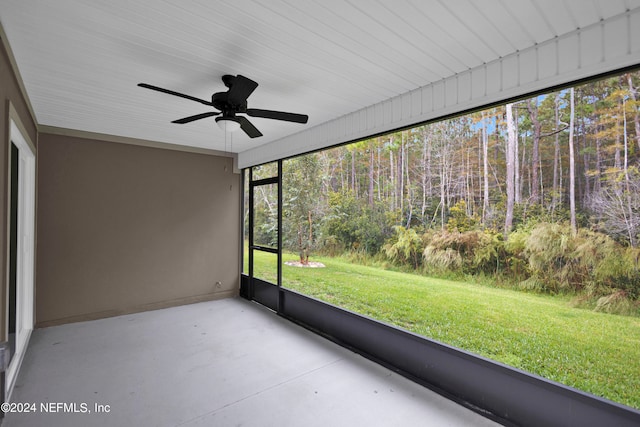 unfurnished sunroom featuring a wealth of natural light and ceiling fan