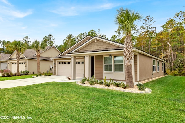 view of front of home with a front yard and a garage