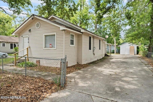 view of side of home featuring a storage unit