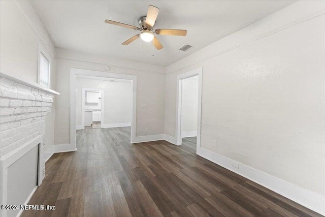 unfurnished living room featuring dark wood-type flooring, a fireplace, and ceiling fan