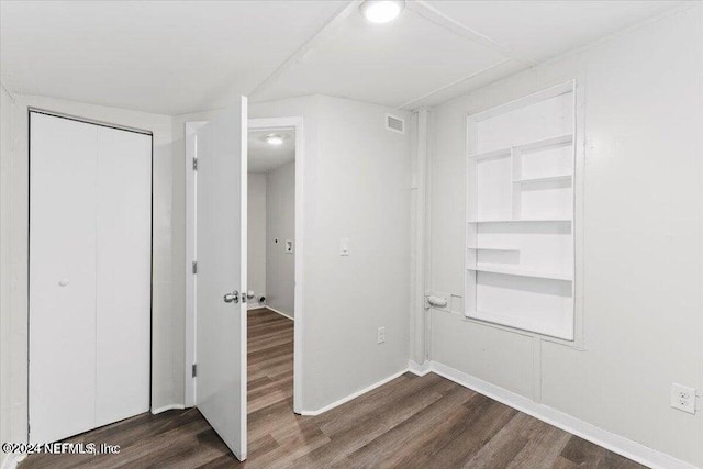 unfurnished bedroom with a closet, ceiling fan, and dark hardwood / wood-style flooring