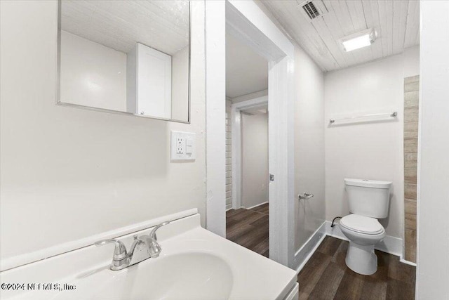 bathroom featuring vanity, toilet, and wood-type flooring