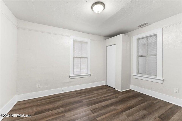 empty room featuring dark hardwood / wood-style flooring