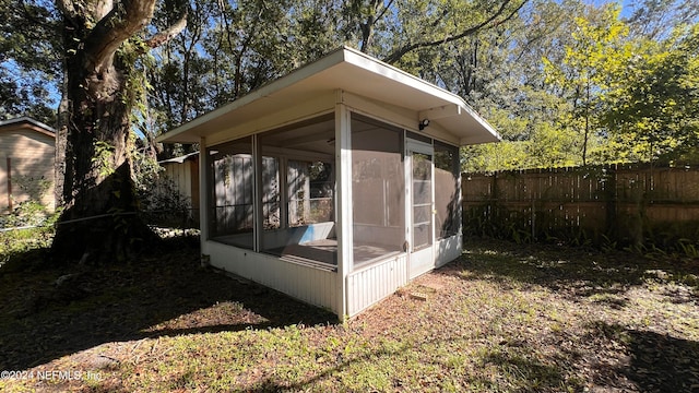 view of outdoor structure with a sunroom