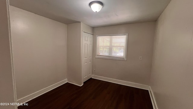 unfurnished room with dark hardwood / wood-style floors