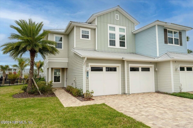 244 Rum Runner Way, Saint Johns, FL 32259 - view of front of house featuring an attached garage, decorative driveway, board and batten siding, and metal roof