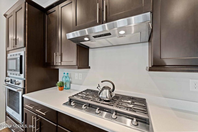 kitchen featuring stainless steel appliances and dark brown cabinets