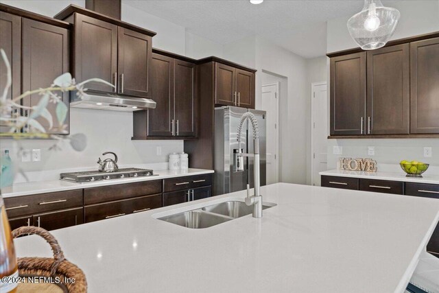244 Rum Runner Way, Saint Johns, FL 32259 - kitchen with a sink, stainless steel gas stovetop, dark brown cabinets, and light countertops
