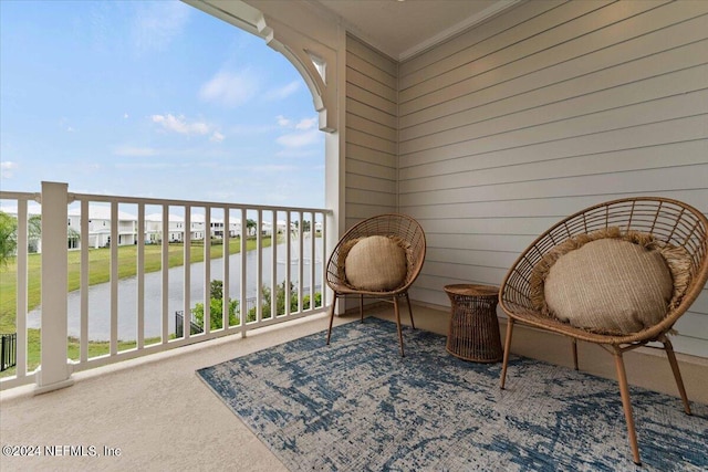 balcony featuring a water view