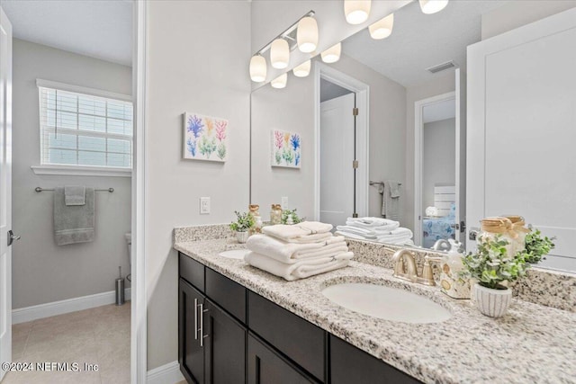 244 Rum Runner Way, Saint Johns, FL 32259 - ensuite bathroom with double vanity, baseboards, and tile patterned floors