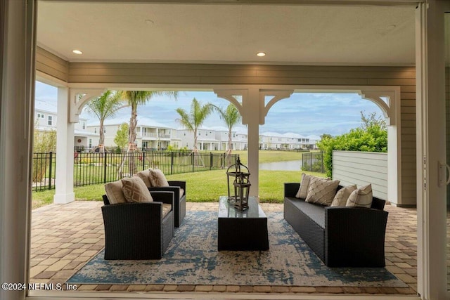 view of patio with an outdoor living space and a water view