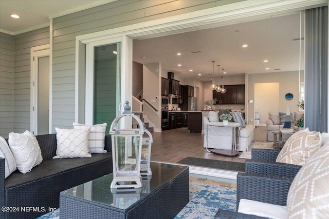 244 Rum Runner Way, Saint Johns, FL 32259 - living area with recessed lighting, wood finished floors, a chandelier, and ornamental molding