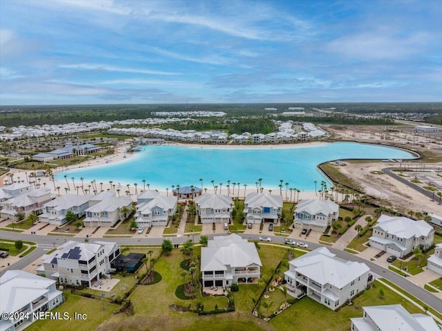 birds eye view of property with a view of the beach and a water view