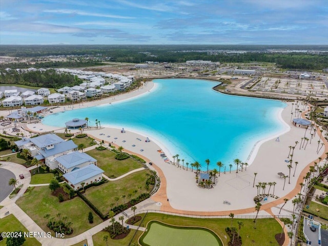 birds eye view of property with a water view and a view of the beach