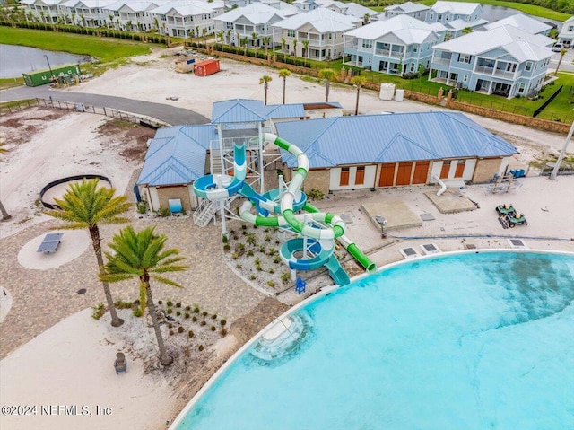 view of swimming pool featuring a water slide and a patio