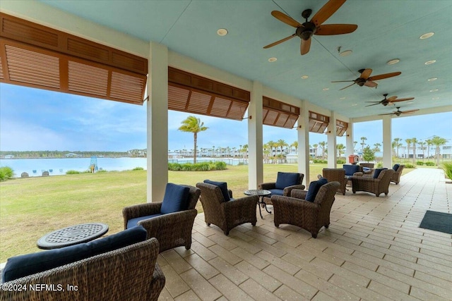 view of patio featuring outdoor lounge area, a water view, and ceiling fan