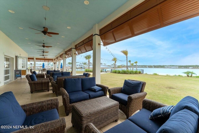 view of patio / terrace featuring a water view, an outdoor living space, and ceiling fan