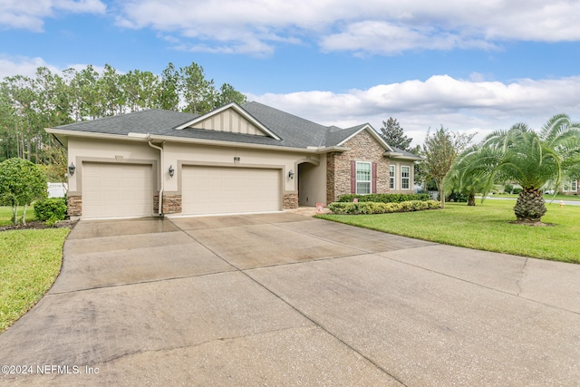 view of front of house featuring a garage and a front lawn