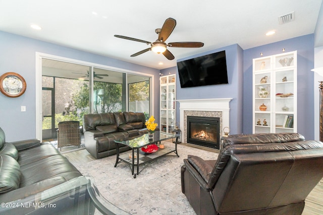 living room with ceiling fan and light wood-type flooring