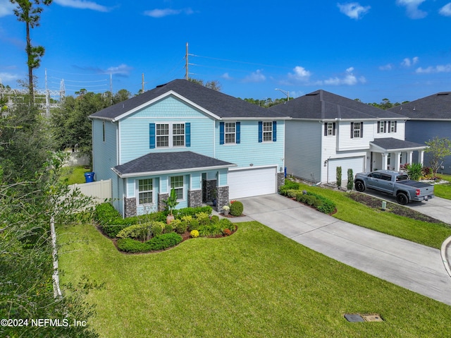 view of front of house with a front yard and a garage