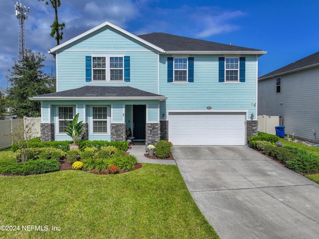 view of front of home featuring a garage and a front lawn