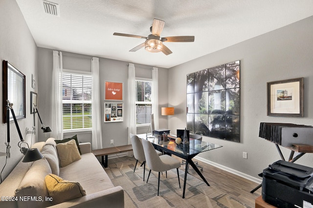 office featuring hardwood / wood-style floors, ceiling fan, and a textured ceiling