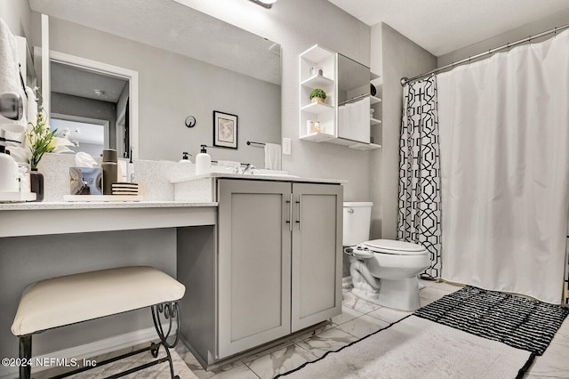 bathroom with vanity, toilet, and a textured ceiling