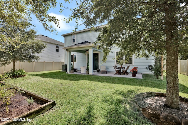 back of house featuring a lawn, a patio area, and central air condition unit