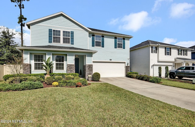 view of front of house with a garage and a front yard