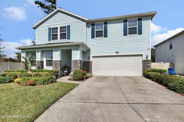 view of front facade with a front yard and a garage