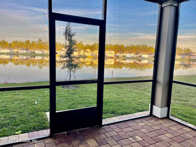 unfurnished sunroom with a water view