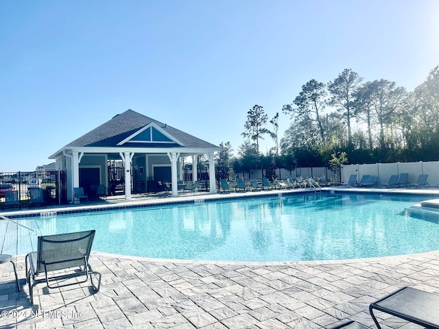 view of swimming pool with a patio