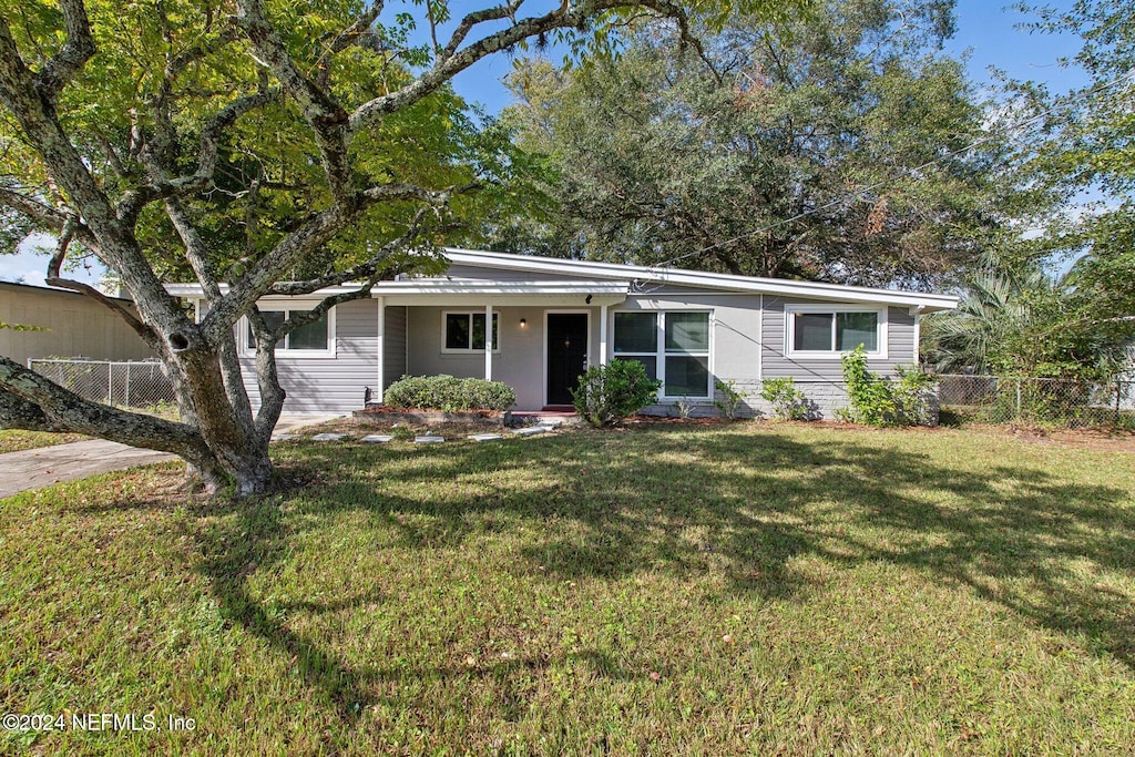 ranch-style house with a front lawn