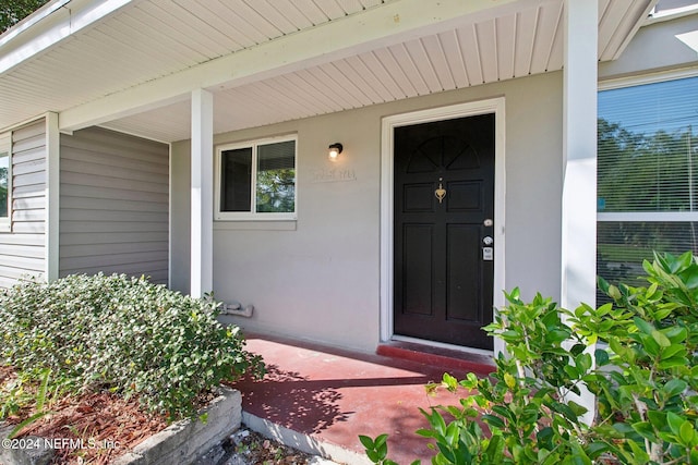 doorway to property featuring a porch